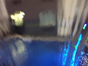 a blurry image of a pool of water in a dark room at Super 8 by Wyndham Bedford DFW Airport West in Bedford