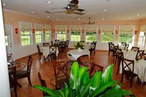 a dining room with tables and chairs and windows at Dublin Farm in Dublin