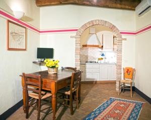 een keuken en eetkamer met een tafel en stoelen bij Cinigiano in Cinigiano