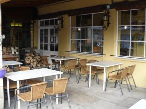 a group of tables and chairs in front of a building at Auberge La Pignata in Montélimar