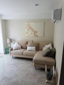 ein Wohnzimmer mit einem Sofa und einem Tisch in der Unterkunft Departamento en Acapulco Diamante in Acapulco