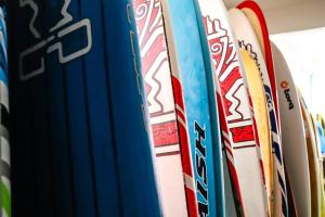 a row of surfboards lined up in a rack at Yousurf Surf House in Essaouira