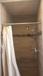 a shower with a white shower curtain in a bathroom at Black Hawk Lodge in Coarsegold