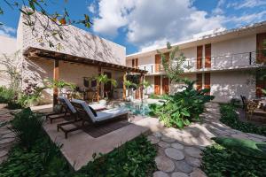a courtyard of a house with chairs and a pool at Colonte Hotel Origen in Valladolid