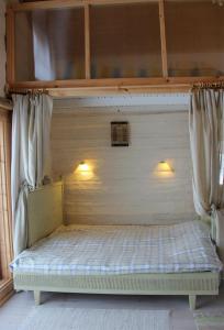 a canopy bed with two lights on top of it at Valonranta Cottage in Kalmari