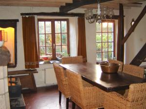 a dining room with a wooden table and chairs at Maurenne in Hastière-Lavaux