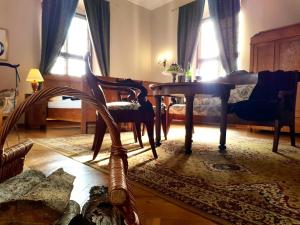 a living room with a table and a chair at Zamek Joannitów in Łagów