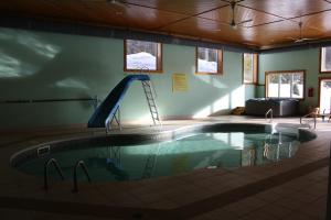 a swimming pool with a slide in a building at Pathsaala Inn & Restaurant in Perth