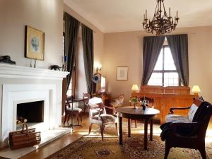 a living room with a fireplace and a table and chairs at Zamek Joannitów in Łagów