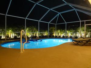 a swimming pool with a tent at night at Luxury and the beach in Naples