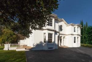 a large white house with a large driveway at The Manor in Torquay