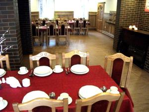 a table with a red tablecloth and chairs and a red table sidx sidx sidx at Ani Konferencje imprezy Wypoczynek in Borne Sulinowo