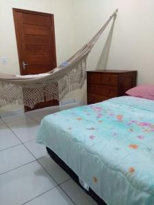 a bedroom with a bed and a hammock at CASA para até 10 PESSOAS in Boa Vista