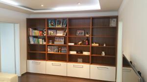 a room with a book shelf with books at Byt v centre mesta Martin in Martin