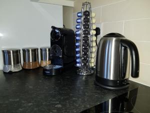 eine Arbeitsplatte mit einer Kaffeemaschine und einer Kaffeekanne in der Unterkunft Victory House in Southampton