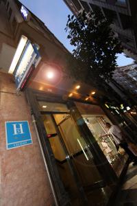 a building with a sign on the side of it at Hostal Victoria in Málaga