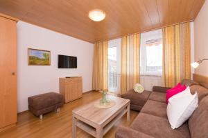 a living room with a couch and a table at Appartement Roland in Strobl