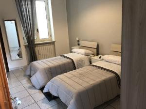 Postel nebo postele na pokoji v ubytování Al cortile