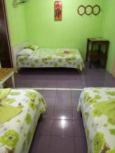 Ένα ή περισσότερα κρεβάτια σε δωμάτιο στο Hotel Margarita Sierpe