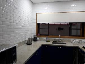 a kitchen with a sink and a counter top at Casa Centro De Ubatuba in Ubatuba +11 photos
