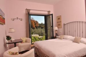 a bedroom with a bed and a window with a view at Chiusa della Vasca in Castelnuovo di Farfa +36 photos