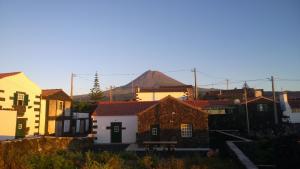 a group of houses with a mountain in the background at Casinha da Avó Jerónima RRAL 1519 in Madalena