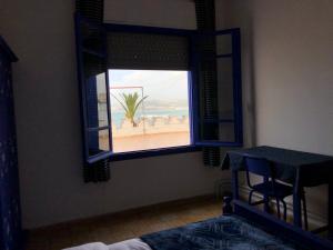 a room with a window with a view of the beach at El Muniria in Tangier