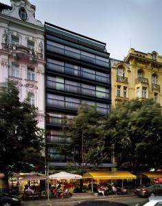 a city street filled with lots of tall buildings at Design Metropol Hotel Prague in Prague