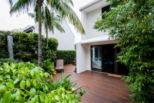 a porch of a house with a wooden deck at Barbados Noosa in Noosaville
