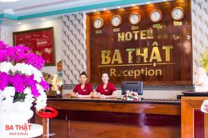 two women sitting at a hotel reception desk at Ba That Hotel in Lagi