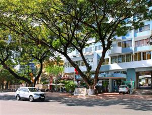 a white car parked in front of a building at Bamboo Green Riverside Hotel in Danang