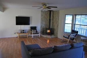 a living room with a couch and a fireplace at Yosemite is Calling in Groveland