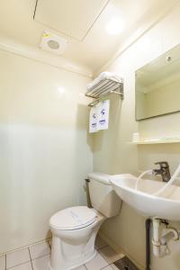 a bathroom with a toilet and a sink at Ruei Gung Business Hotel Kaohsiung in Kaohsiung