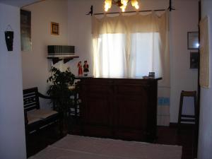 a living room with a window and a wooden door at Bed & Breakfast Dessole in Olbia
