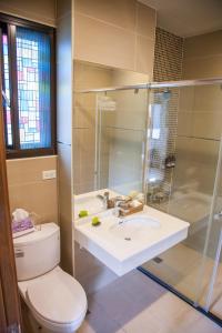 a bathroom with a toilet and a sink and a shower at Stay Homestay in Toucheng