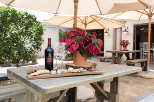 a table with a bottle of wine and wine glasses at Our Heritage Guesthouse in Kempton Park