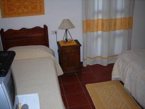 a bedroom with two beds and a lamp on a night stand at Bed & Breakfast Dessole in Olbia