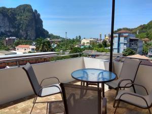 a balcony with a table and chairs and a view at De Loft Hotel in Ao Nang Beach