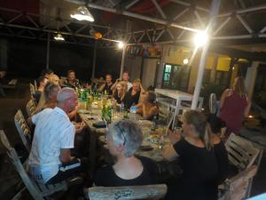 a group of people sitting around a long table at Casus Dream Hotel in Gili Trawangan