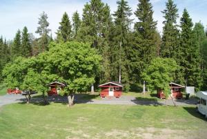 a group of cottages in a park with trees at Seinäjoen leirintäalue in Seinäjoki