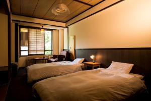 Posteľ alebo postele v izbe v ubytovaní Takamiya Hotel Hammond