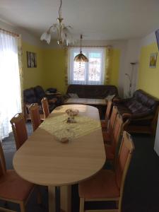 a living room with a table and chairs and a couch at Holiday Home U Fišerů in Kašperské Hory