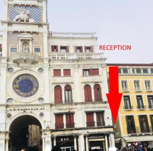 a building with a clock on the side of it at Bellevue Luxury Rooms - San Marco Luxury in Venice