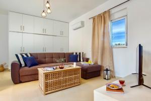 a living room with a couch and a table at Summer Breeze Villa in Afantou