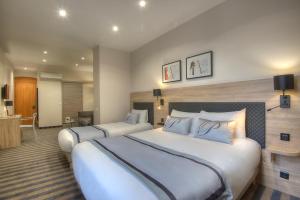 Postel nebo postele na pokoji v ubytování Hotel Paganini