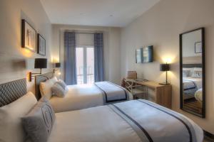 Postel nebo postele na pokoji v ubytování Hotel Paganini