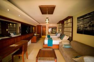 a hotel room with two beds and a couch at Fairway Boutique Hotel - Kampala, Uganda in Kampala