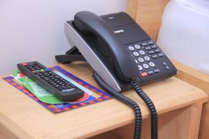 a black phone and a calculator on a desk at Explorers Hub in Kampala