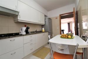 uma cozinha com uma mesa com uma taça de fruta em Apartamento Orquidea no Funchal