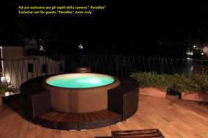 a large pool sitting on a deck at night at Hotel Argentina in Santa Margherita Ligure
